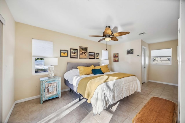 bedroom with visible vents, ceiling fan, baseboards, and light tile patterned flooring