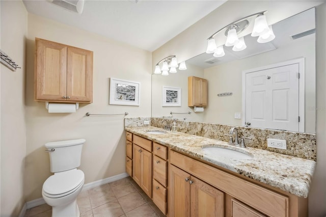 full bath with double vanity, tile patterned flooring, a sink, and toilet