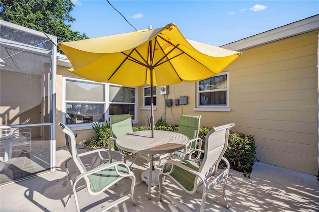 view of patio with a lanai and outdoor dining area