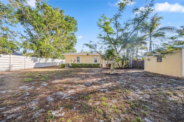 view of yard with an outbuilding, cooling unit, and a fenced backyard