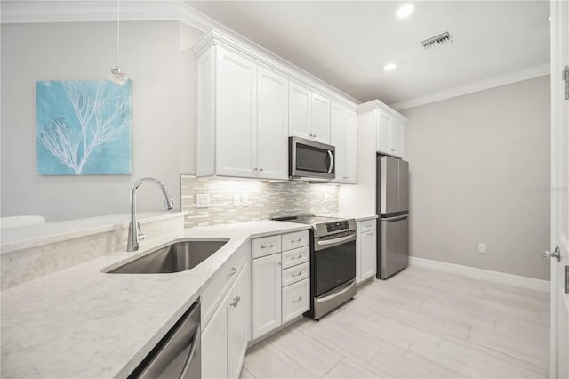 13867 Vadini St, Venice, FL 34293 - kitchen featuring visible vents, white cabinets, a sink, ornamental molding, and stainless steel appliances