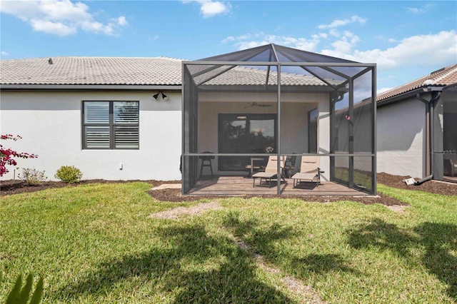 13867 Vadini St, Venice, FL 34293 - rear view of property with a tiled roof, a ceiling fan, a lawn, stucco siding, and a lanai