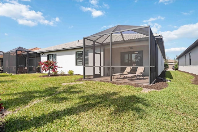 13867 Vadini St, Venice, FL 34293 - rear view of property with a tiled roof, a yard, stucco siding, a patio area, and a lanai