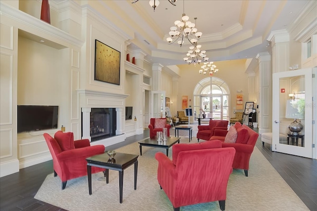 13867 Vadini St, Venice, FL 34293 - living room featuring a tray ceiling, crown molding, an inviting chandelier, and dark wood finished floors