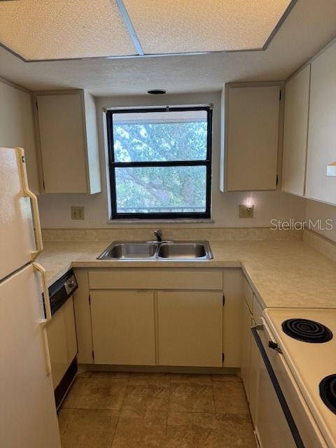 kitchen featuring sink and white appliances