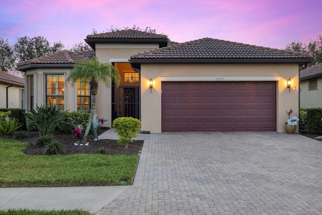 mediterranean / spanish-style house with a garage