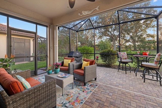 sunroom featuring ceiling fan