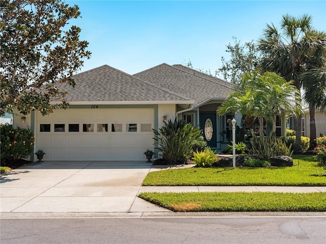 single story home featuring driveway, stucco siding, an attached garage, and roof with shingles