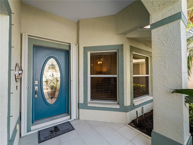 view of exterior entry featuring stucco siding