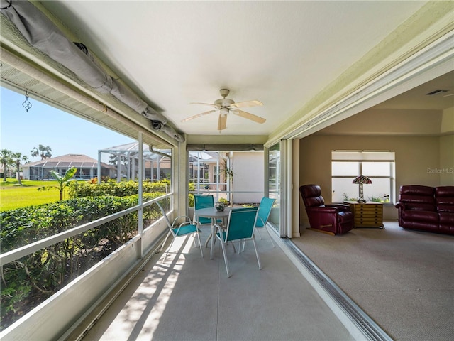 sunroom featuring ceiling fan and visible vents