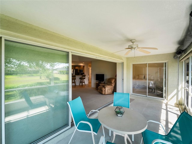 sunroom / solarium with a ceiling fan