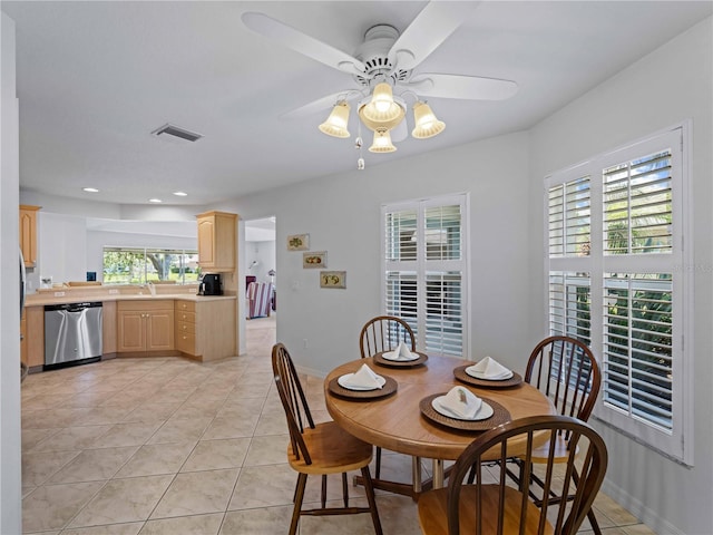 dining space with light tile patterned floors, baseboards, visible vents, and ceiling fan