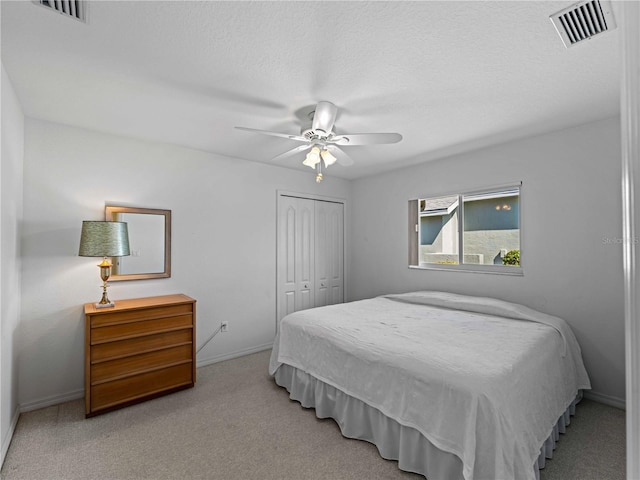 bedroom featuring carpet, a closet, visible vents, and baseboards