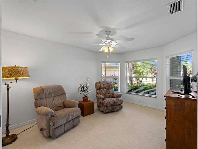 sitting room featuring carpet floors, visible vents, ceiling fan, and baseboards