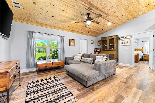 living room with lofted ceiling, wood ceiling, baseboards, and wood finished floors