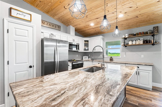 kitchen with stainless steel appliances, glass insert cabinets, a sink, and white cabinetry