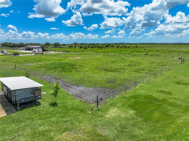 view of yard featuring fence and a rural view