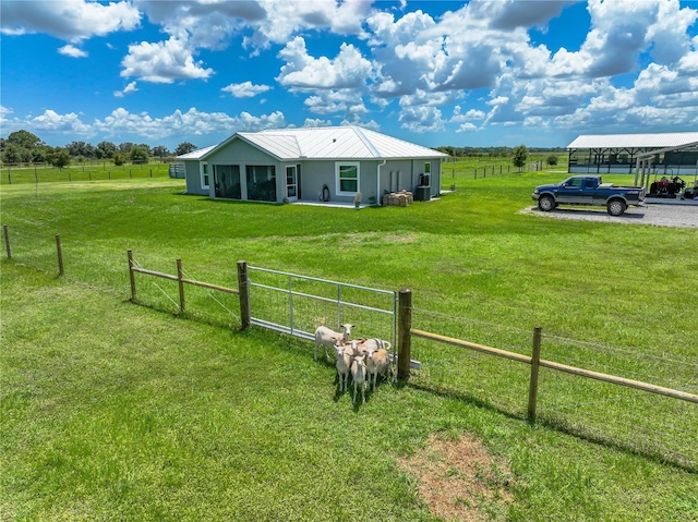 view of yard with a rural view and fence