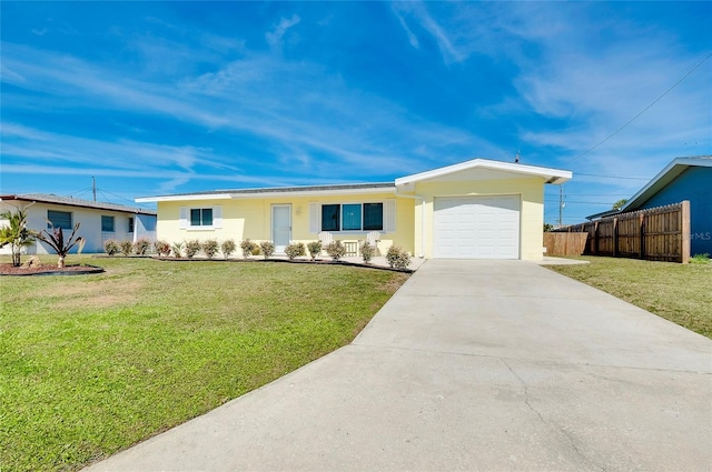 single story home with an attached garage, fence, a front lawn, and concrete driveway