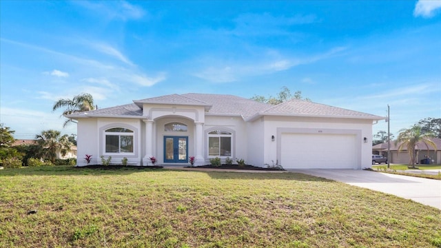 view of front of home with french doors, stucco siding, concrete driveway, a garage, and a front lawn