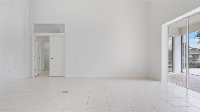 unfurnished room featuring light tile patterned flooring