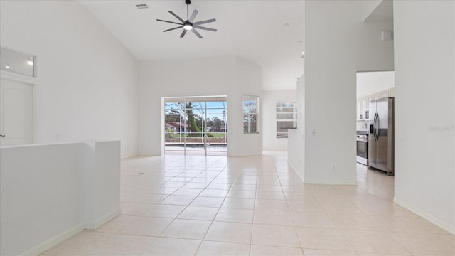 empty room featuring visible vents, a ceiling fan, light tile patterned flooring, high vaulted ceiling, and baseboards