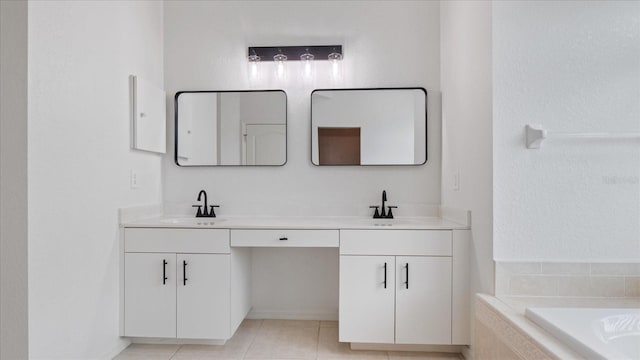 bathroom featuring tile patterned flooring, a sink, tiled tub, and double vanity