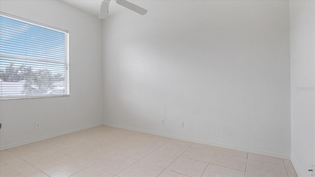 unfurnished room featuring ceiling fan, plenty of natural light, and baseboards