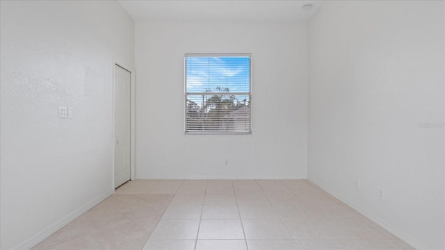 unfurnished room featuring light tile patterned floors