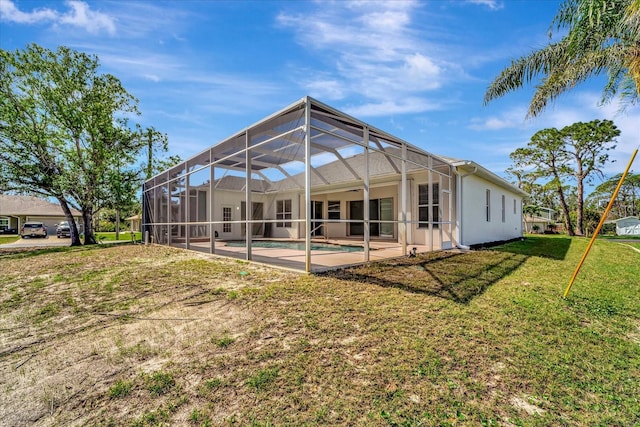 back of house featuring a yard, a patio area, a lanai, and an outdoor pool