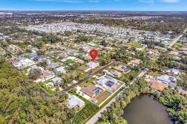 drone / aerial view with a residential view and a water view