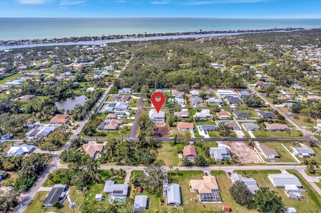 drone / aerial view with a water view and a residential view