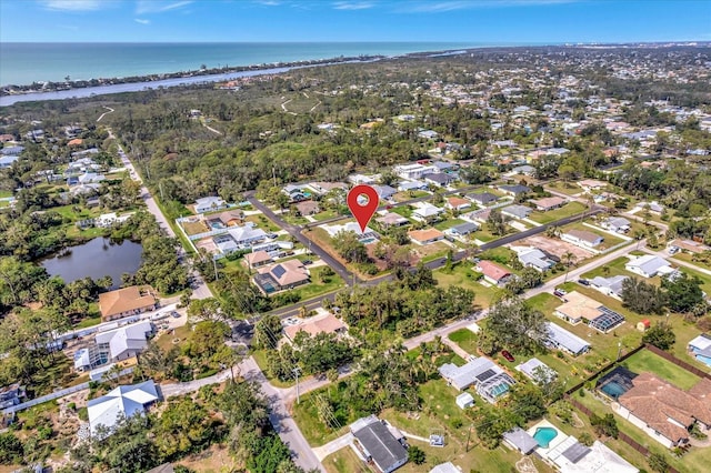 birds eye view of property featuring a water view and a residential view