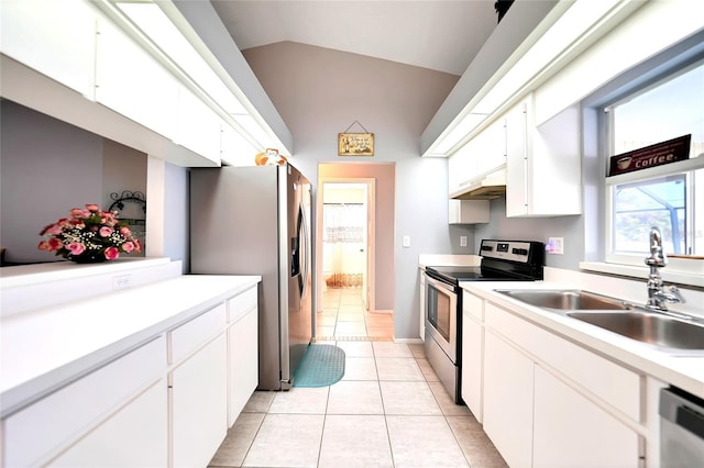 kitchen with lofted ceiling, stainless steel appliances, light countertops, white cabinetry, and a sink