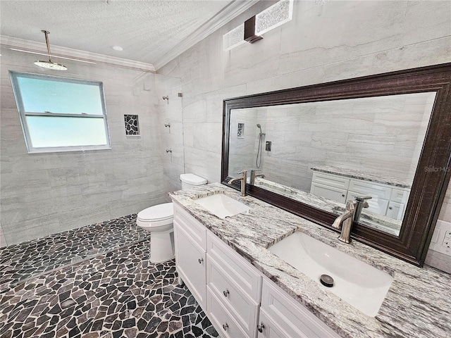 bathroom featuring a tile shower, ornamental molding, a sink, and tile walls