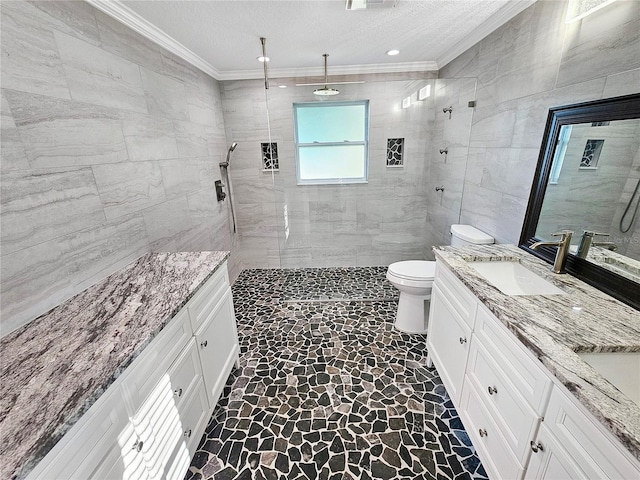 bathroom featuring ornamental molding, a sink, tile walls, and toilet