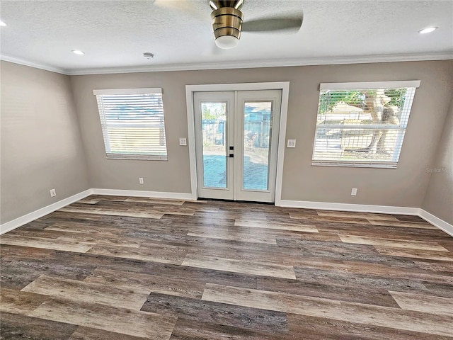 entryway with a textured ceiling, baseboards, french doors, dark wood finished floors, and crown molding