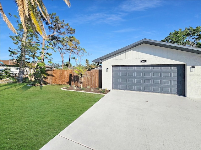 view of property exterior with a garage, fence, concrete driveway, and a yard