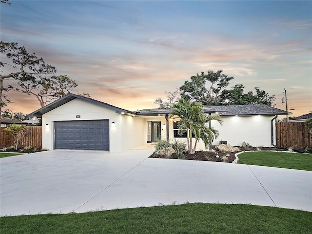 605 Cumberland Rd, Venice, FL 34293 - view of front of property with fence, driveway, and a garage