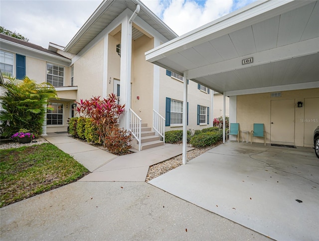 view of exterior entry featuring stucco siding