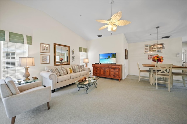 living area featuring carpet floors, high vaulted ceiling, visible vents, and a ceiling fan