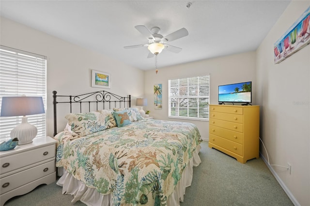 bedroom with baseboards, a ceiling fan, and light colored carpet