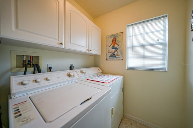 laundry area with cabinet space, independent washer and dryer, and baseboards