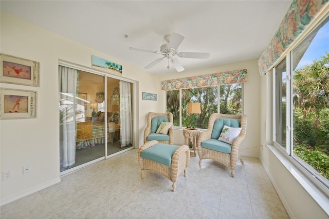 sunroom / solarium featuring a ceiling fan