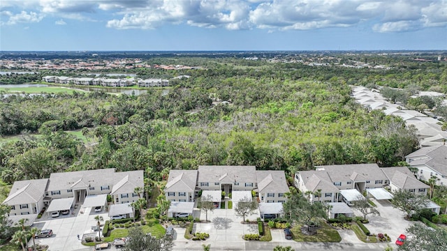 aerial view featuring a residential view and a wooded view