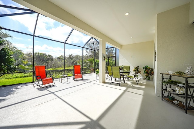 view of patio featuring a lanai