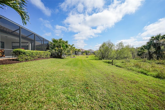 view of yard with glass enclosure