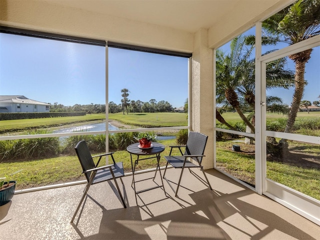 sunroom / solarium with a water view