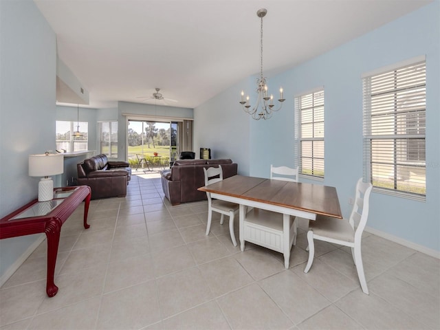 dining area with light tile patterned floors, ceiling fan with notable chandelier, and baseboards