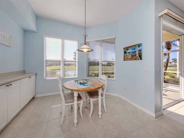 dining room with light tile patterned floors and baseboards